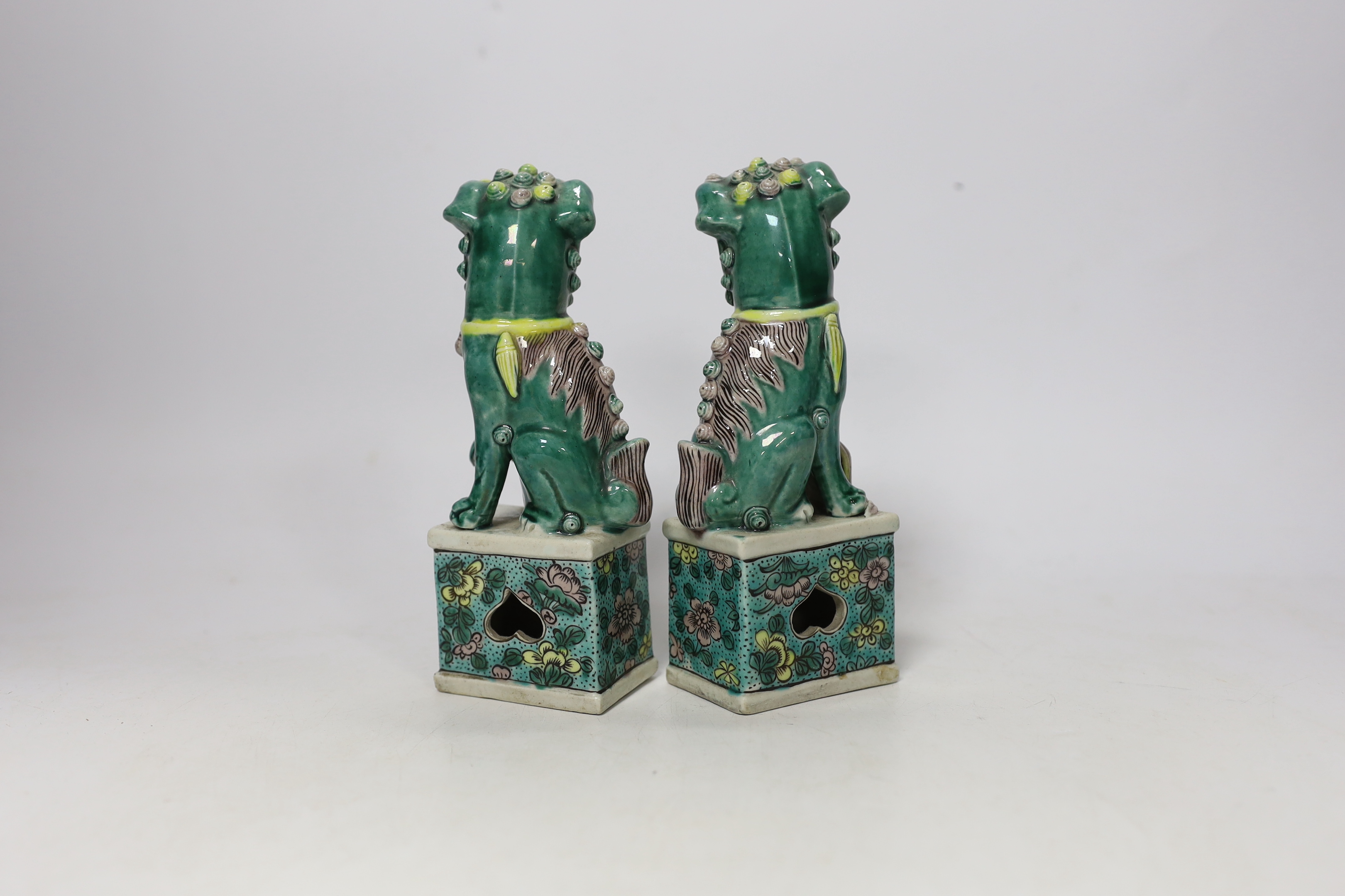 A pair of small early 20th century Chinese figures of Buddhist lions, 15.5cm high